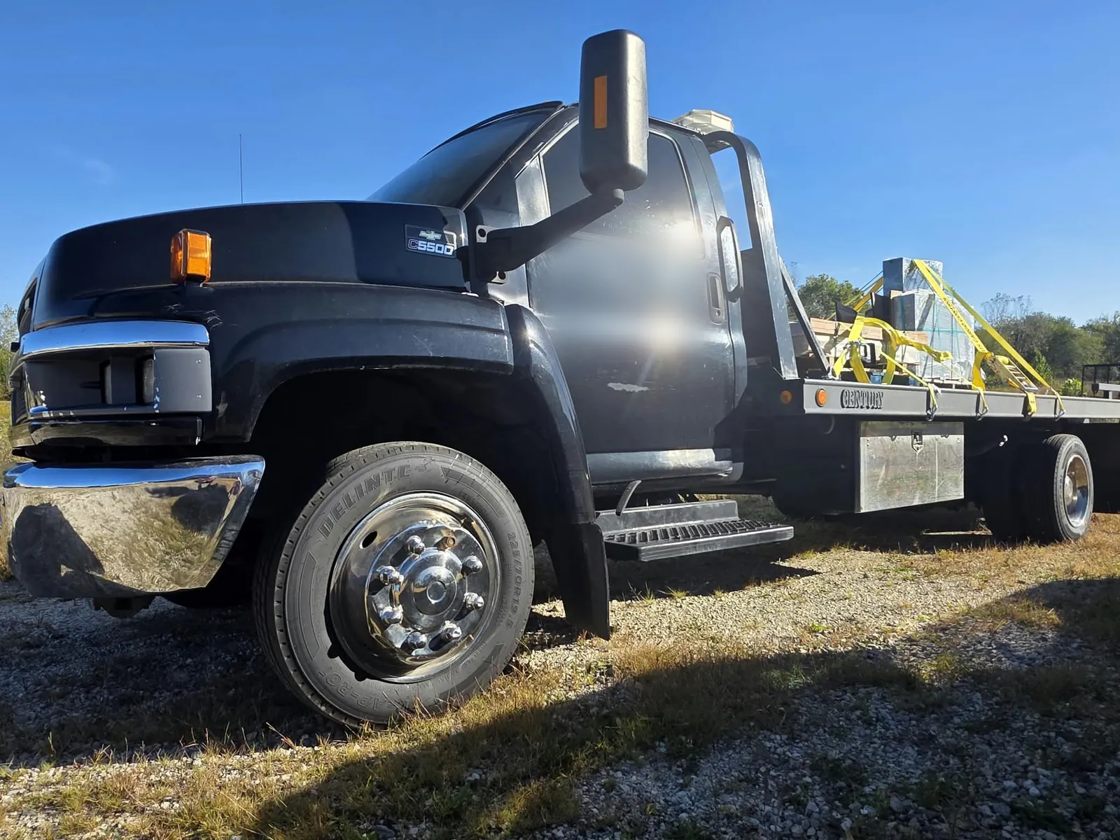 Cardinal flatbed truck with monuments strapped on the bed